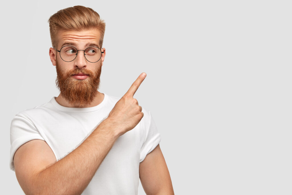 horizontal shot attractive caucasian male has ginger hair beard points with fore finger aside dressed t shirt one colour with wall 1024x683 - Aký je váš názor na dychovú hudbu ?